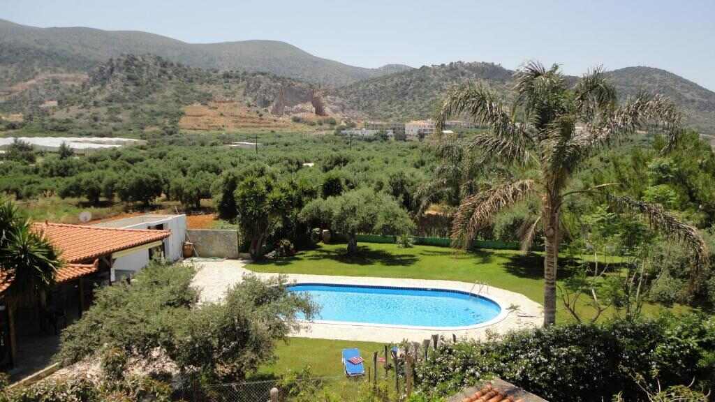Garden and swimming pool of Ibiscus Hotel Malia with mountain views