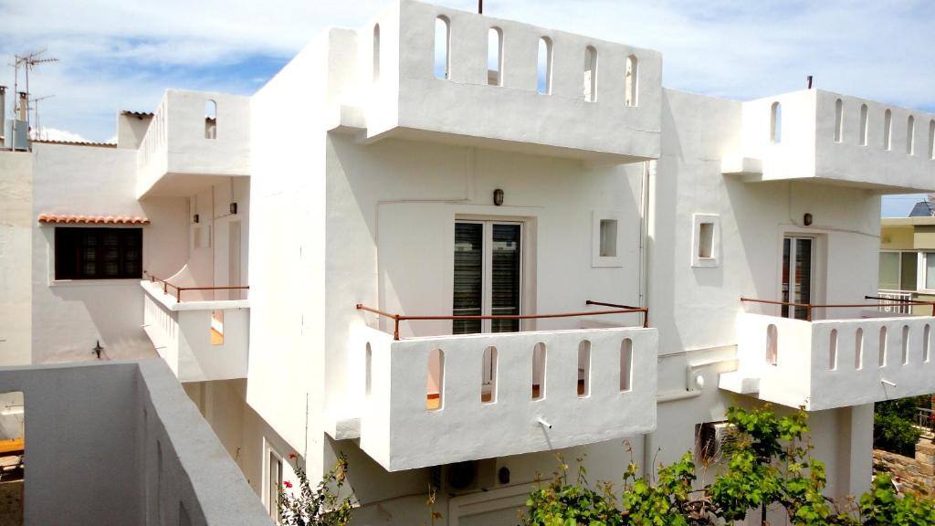 White façade of Ibiscus Hotel Malia with balconies